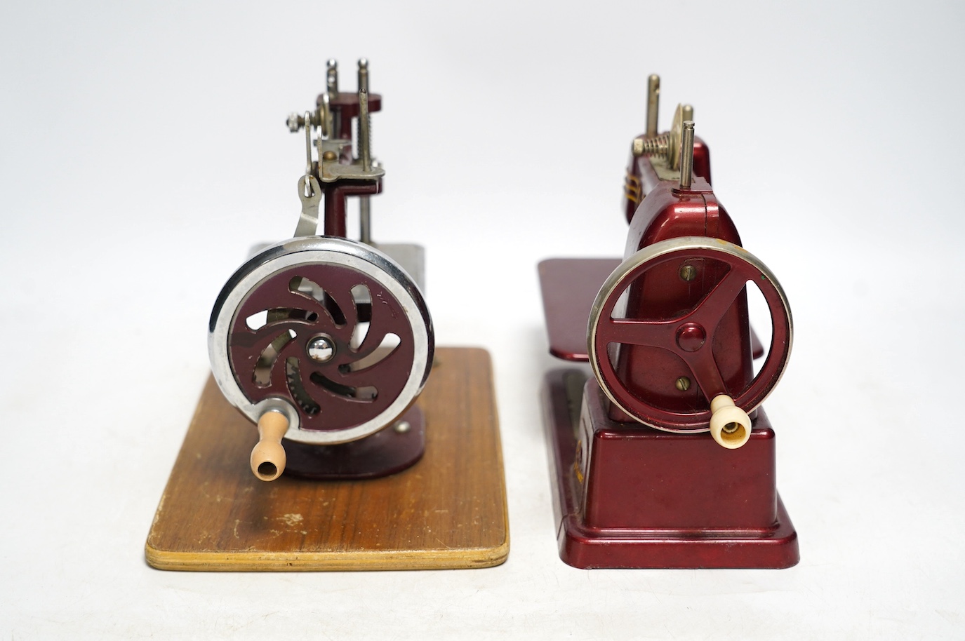 Two mid 20th century child’s sewing machines including a Vulcan Senior sewing machine in metallic red finish. Condition - fair